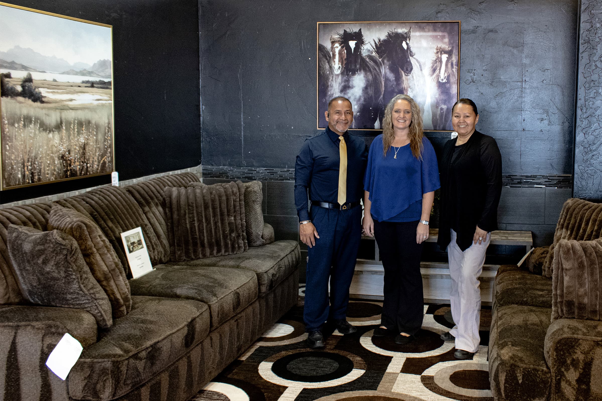 JK Home Furnishings team standing in a showroom setup